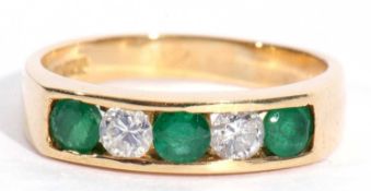 18ct gold emerald and diamond half hoop ring featuring three small round cut emeralds and two