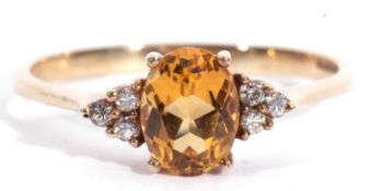 Modern 9ct gold stamped paste set ring centring an oval faceted orange stone with white stone set