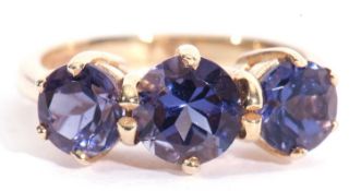 Modern 9ct gold blue three stone ring having three round graduated blue stones raised in coronet