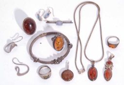 Mixed Lot: white metal and amber ring, two amber pendants, three further amber set rings, etc