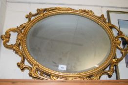 OVAL BEVELLED WALL MIRROR IN A GILT FINISH METAL FRAME