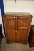 MID-20TH CENTURY OAK DOUBLE DOOR TALLBOY CABINET WITH LINENFOLD DECORATION