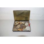 SMALL TIN CONTAINING MILITARY CAP BADGES AND VARIOUS WORLD COINAGE