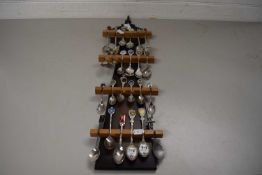 COLLECTION OF CRESTED COLLECTORS SPOONS ON A WOODEN HOLDER
