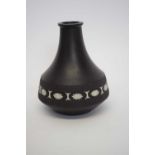 Wedgwood black basalt vase with floral design together with a Moorcroft pin dish, the vase 18cm high