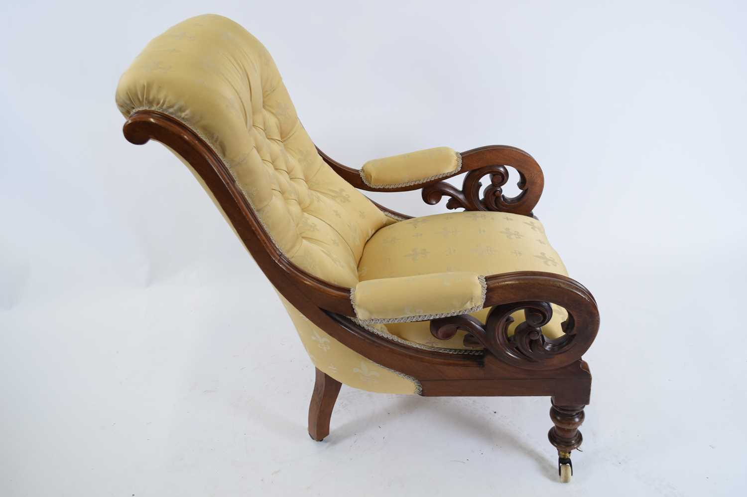 Victorian mahogany framed scroll arm chair upholstered in yellow buttoned fabric, raised on turned - Image 2 of 3