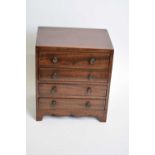 Antique mahogany four drawer apprentice chest with knob handles and bracket feet, 24cm wide