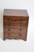 Antique mahogany four drawer apprentice chest with knob handles and bracket feet, 24cm wide