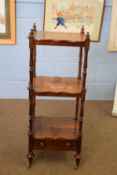 Victorian rosewood three tier whatnot with turned supports and base drawer raised on small brass