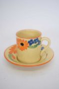 A Newport pottery floral decorated coffee can and saucer
