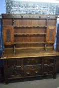 Late 19th century oak dresser, the top section with shelves and two small cupboards over a base with