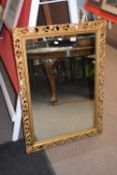 Rectangular wall mirror in carved gilt wood foliate decorated frame, 98cm high