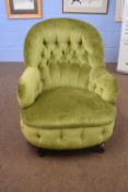 Victorian green upholstered button back armchair on short turned legs with casters, 78cm high