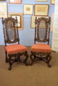 Pair of 19th century Carolean style cane backed chairs with elaborate carved frames and