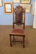 Victorian Gothic oak hall chair with leather upholstered seat and back, decorated with carved