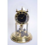 Kundo brass torsion or anniversary clock set under a glass dome, 30cm high