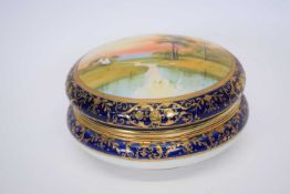 Large Noritake box and cover, the cover painted with a landscape scene within gilt and blue borders,