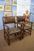 Pair of late 19th/early 20th century oak framed and brown leather upholstered carver or armchairs