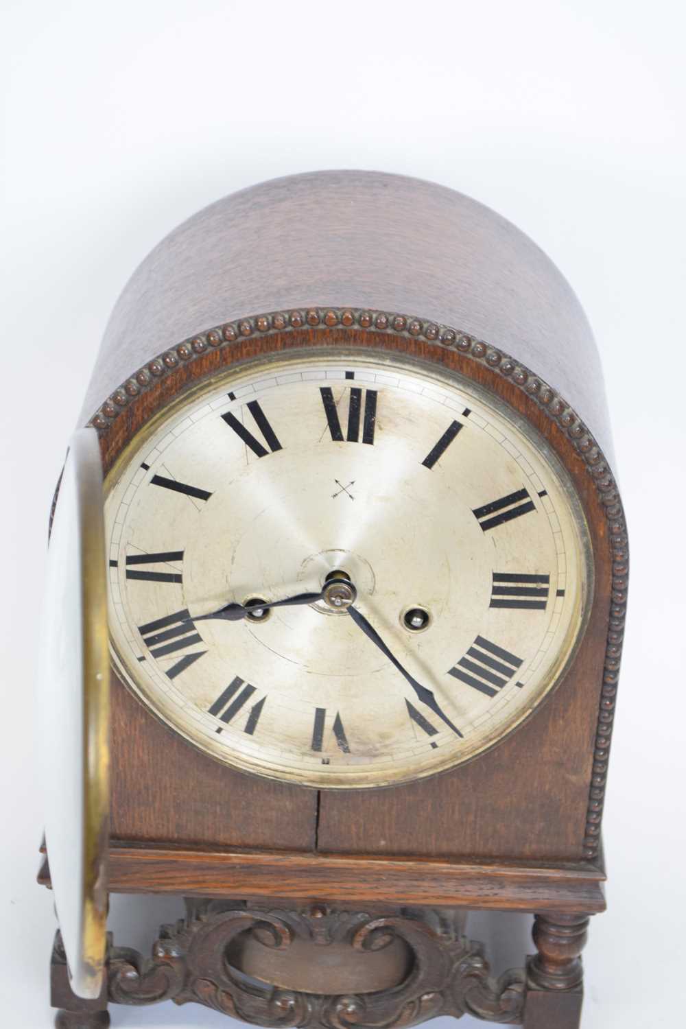 Early 20th century oak cased mantel clock of domed form raised on small turned legs with the unusual - Image 2 of 3