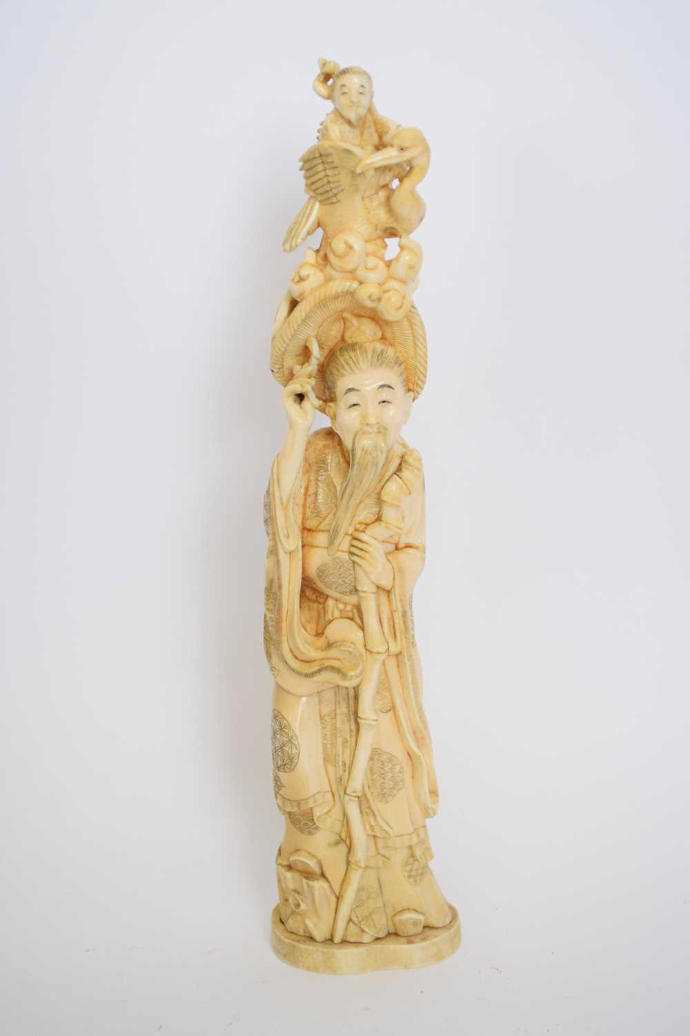 Large Chinese or Japanese figure modelled as an elderly man with a bird and further figure above his