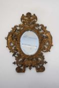 Oval mirror in gilt metal frame, the frame modelled with cherubs, 30cm high