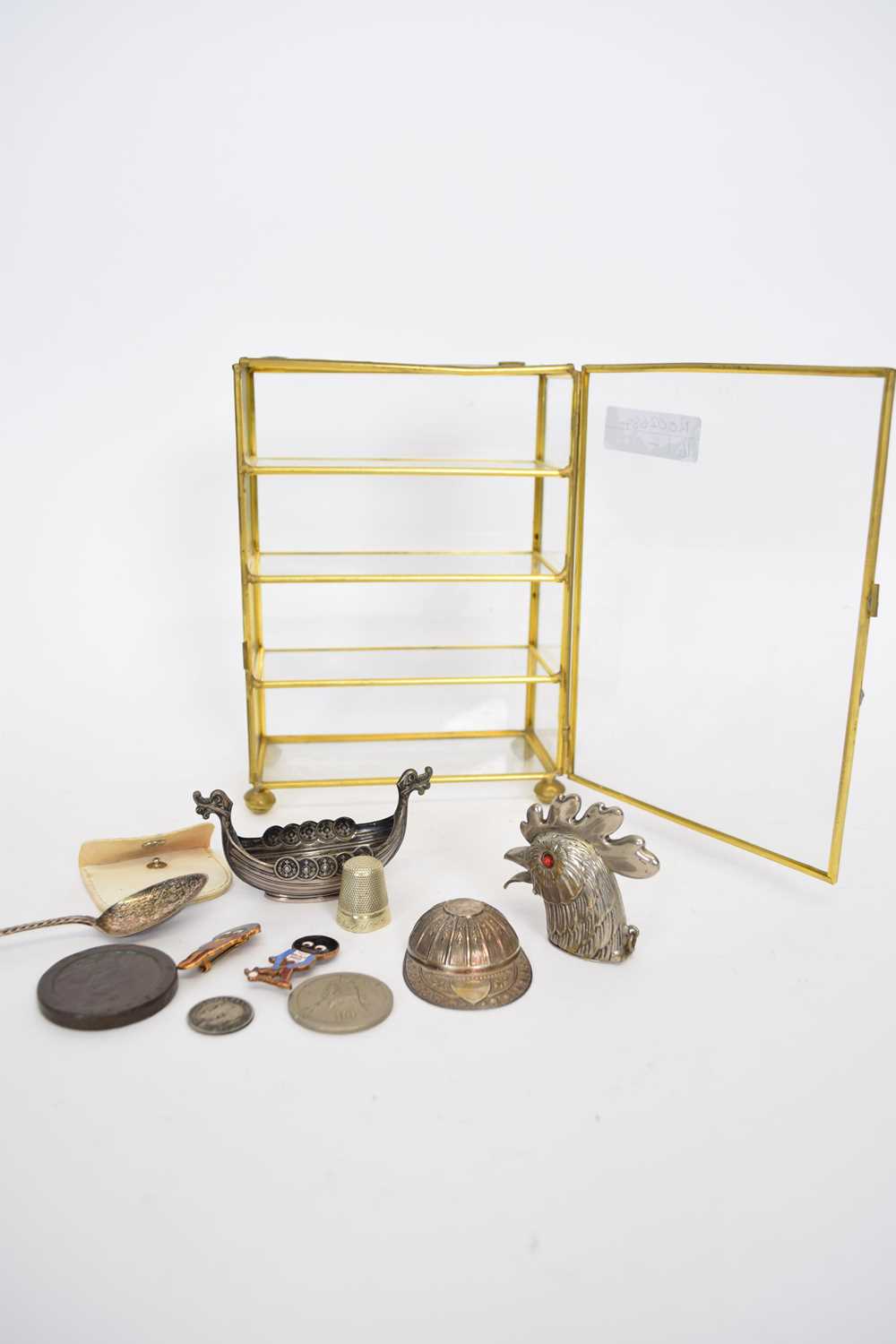 Miniature glazed table top display cabinet containing various small novelty items to include a white