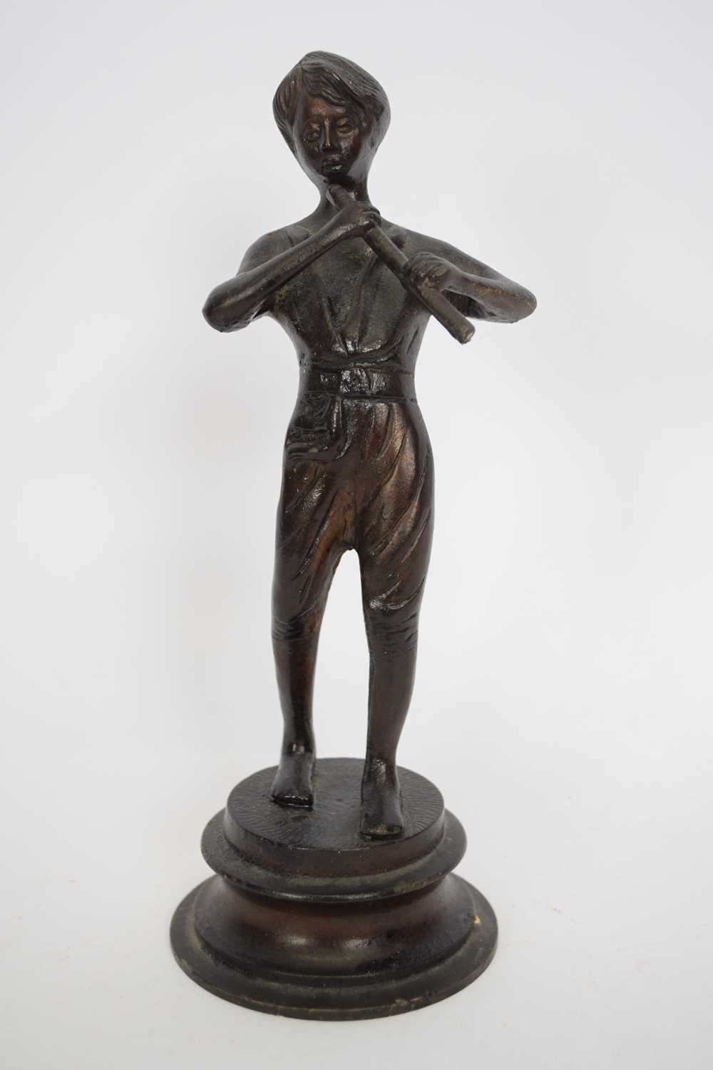 20th century bronzed metal model of a boy playing a flute, raised on a circular plinth base, 24cm