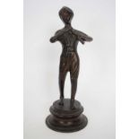 20th century bronzed metal model of a boy playing a flute, raised on a circular plinth base, 24cm