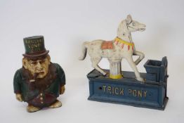 Two novelty iron money boxes, one marked 'Transvaal Money Box', the other marked 'Trick Pony',