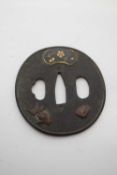 Metal Tsuba with designs in relief including a fish and shell, 7cm diam