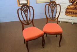 Pair of Edwardian mahogany framed side chairs with pierced back, red upholstered seats and cap front