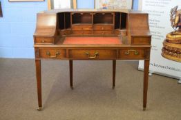 20th century mahogany veneered Carlton House type desk, the arched back with drawers and pigeonholes