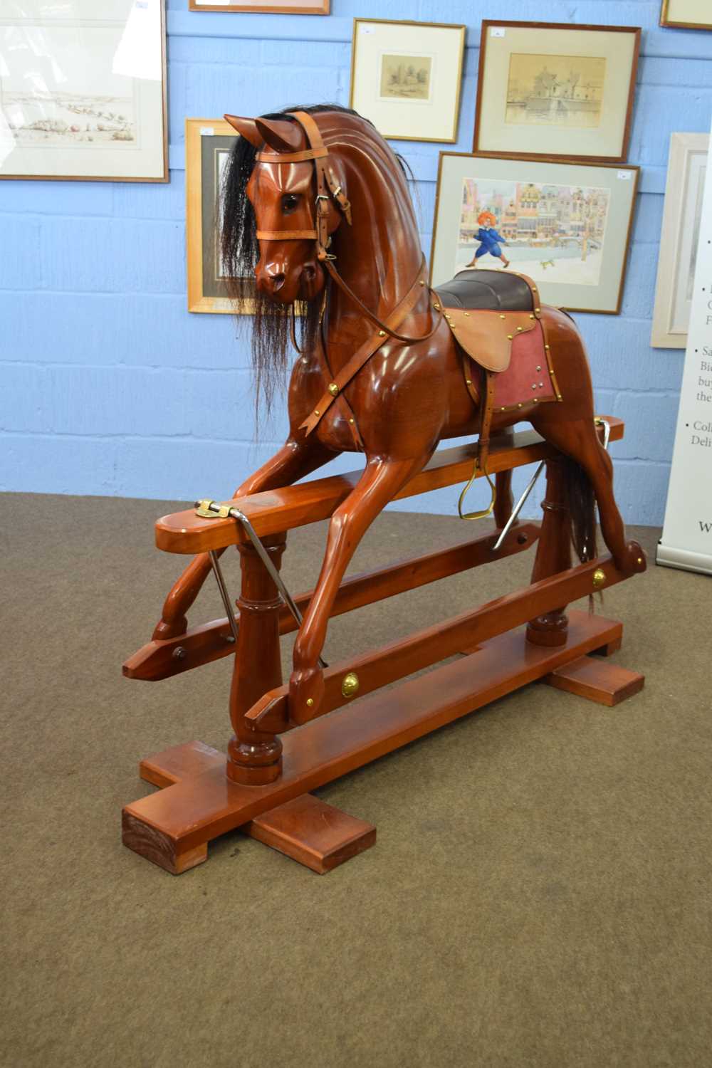 Contemporary hardwood rocking horse of traditional design raised on turned supports, 140cm long