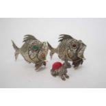 Pair of Spanish white metal pepperettes formed as fish, 6cm long, together with a further