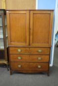 19th century mahogany linen press cupboard with two panelled doors over a three drawer base raised