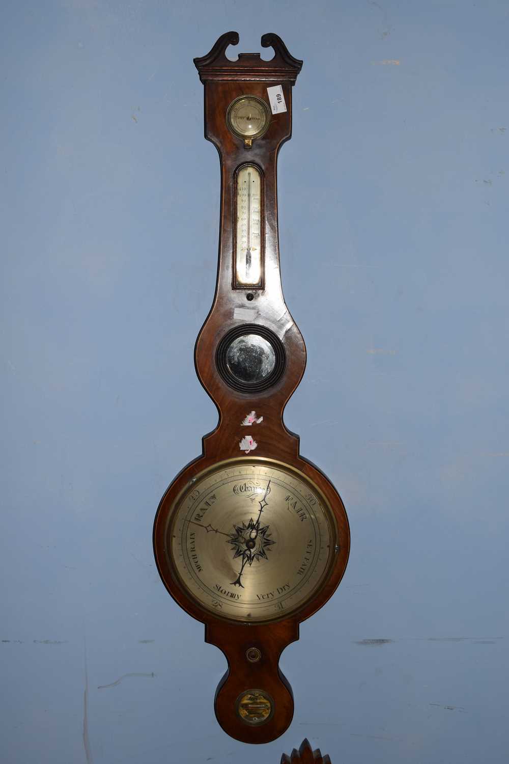 19th century mahogany cased barometer with broken arch pediment over a body with damp/dry meter,