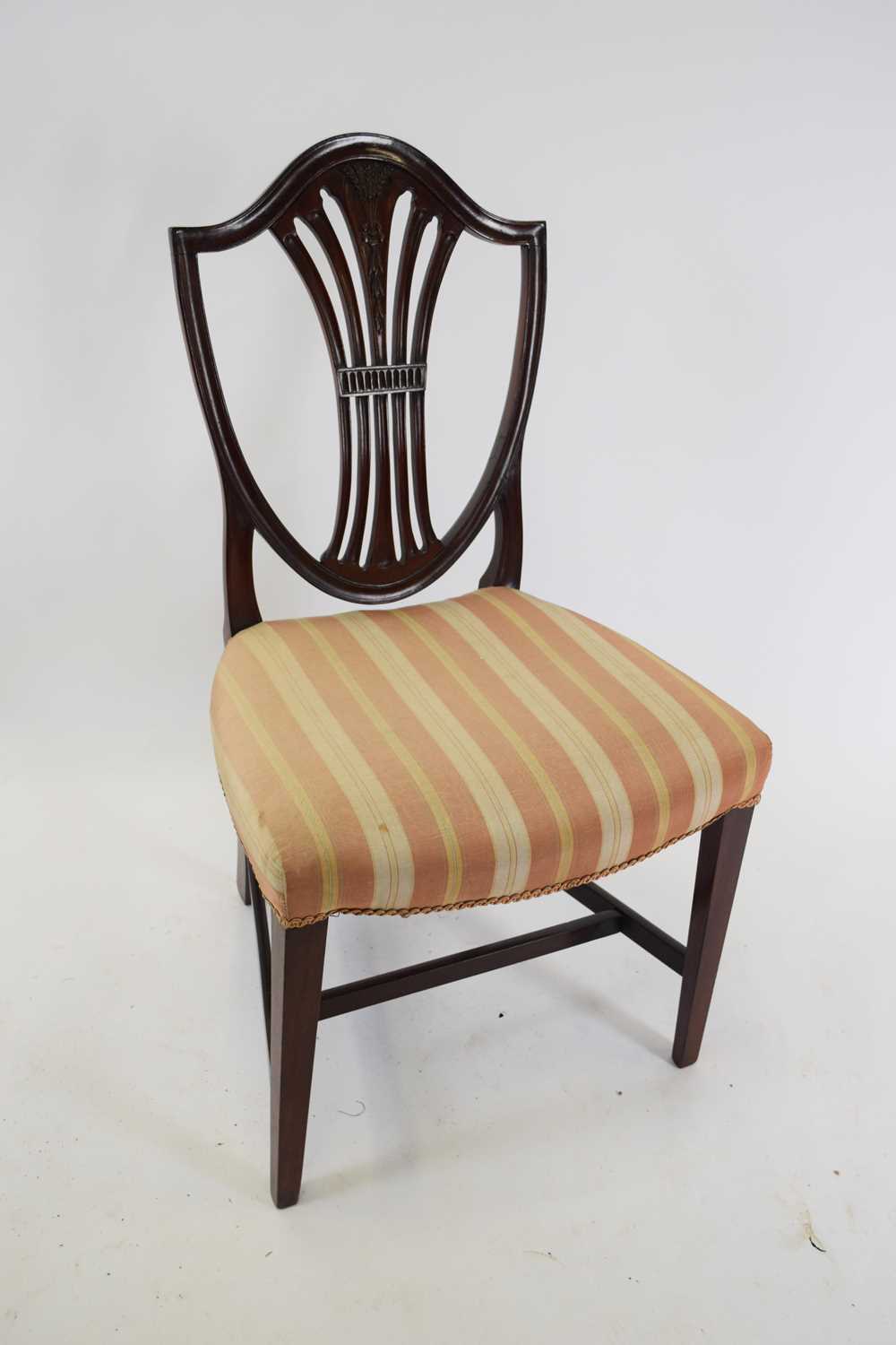 Mahogany framed shield back dining chair decorated with wheatsheaf detail and upholstered in striped