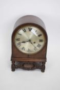 Early 20th century oak cased mantel clock of domed form raised on small turned legs with the unusual