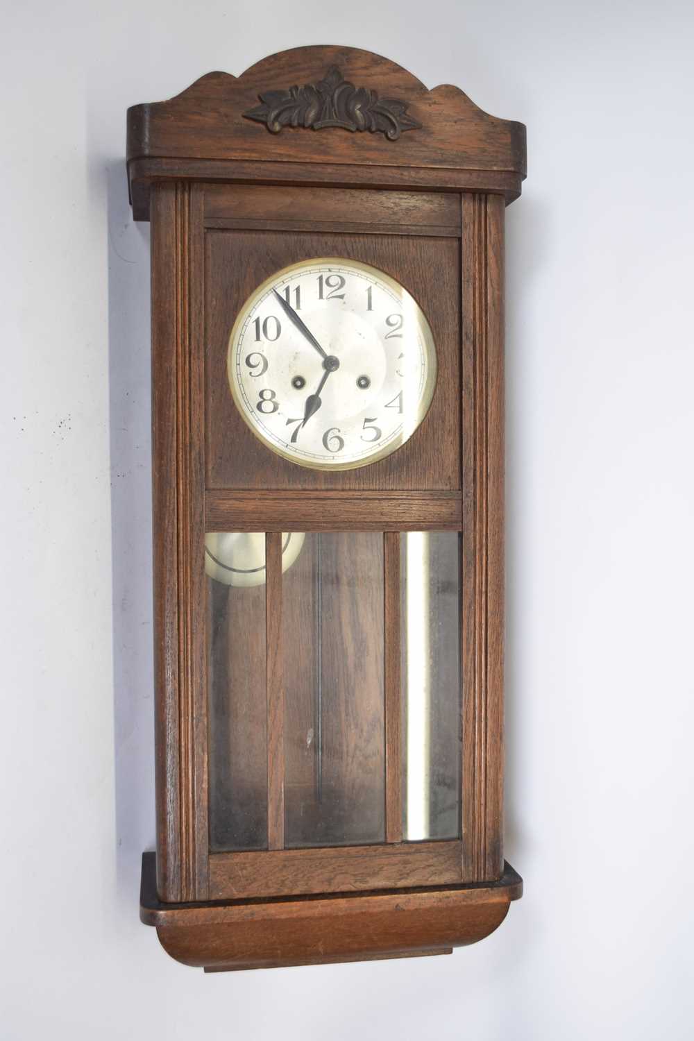 Early 20th century wall clock in oak case with silvered dial, Arabic numerals, twin train