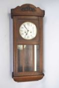 Early 20th century wall clock in oak case with silvered dial, Arabic numerals, twin train