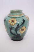 Pottery vase with tube lined floral design in Moorcroft style