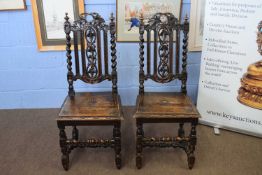 Pair of late Victorian Gothic oak high back hall chairs with barley twist supports and carved vine