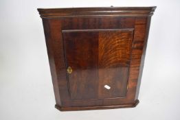 Small 20th century oak corner cabinet with moulded cornice and single door opening to a painted