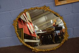 20th century oval wall mirror set in a gilt metal foliate frame, 86cm high