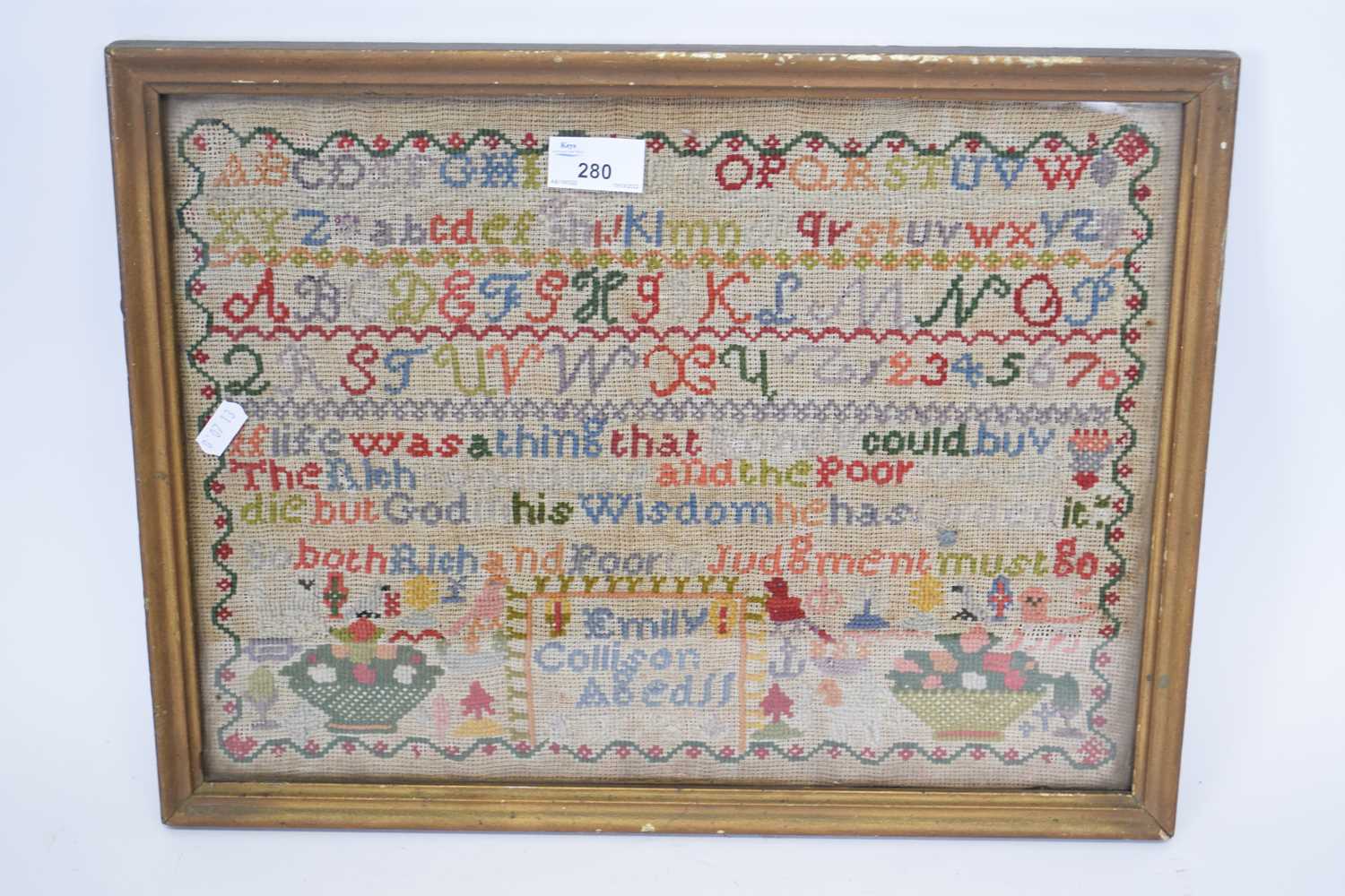 Victorian needlework sampler decorated with rows of letters and religious text, signed 'Emily