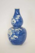 19th century Chinese porcelain vase of double gourd shape decorated with prunus on a washed blue