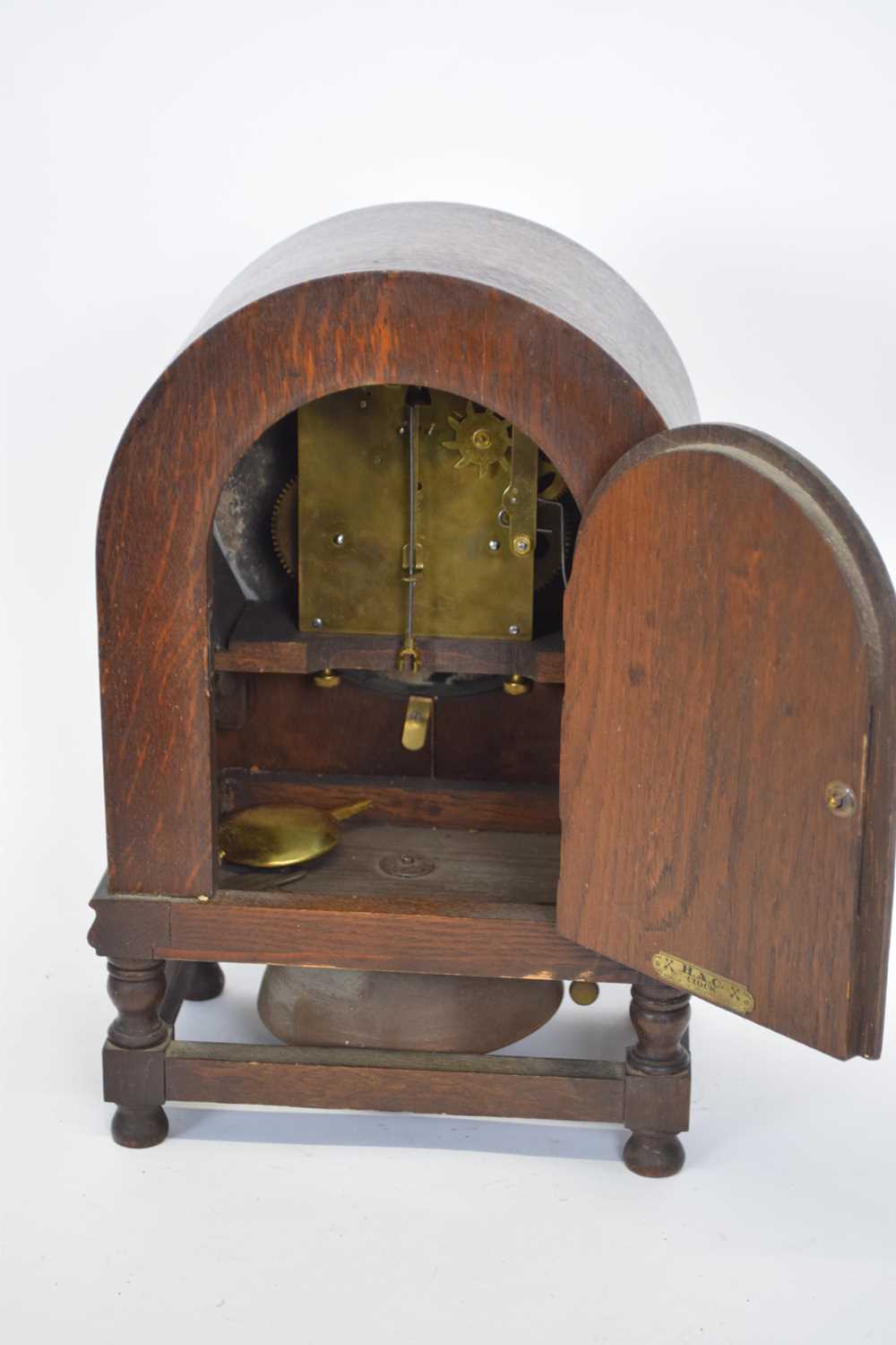 Early 20th century oak cased mantel clock of domed form raised on small turned legs with the unusual - Image 3 of 3