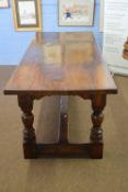 Eric Bates & Sons oak refectory style dining table raised on heavy turned legs with H stretcher,