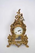 20th century Continental brass cased mantel clock, the elaborate foliate moulded case to an enamel