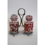 Silver plated cruet containing a pair of clear and red vine decorated lidded jars